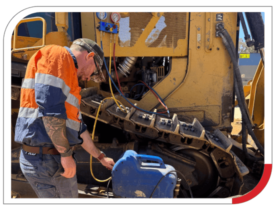 Technician inspecting construction equipment for optimal diesel engine performance.